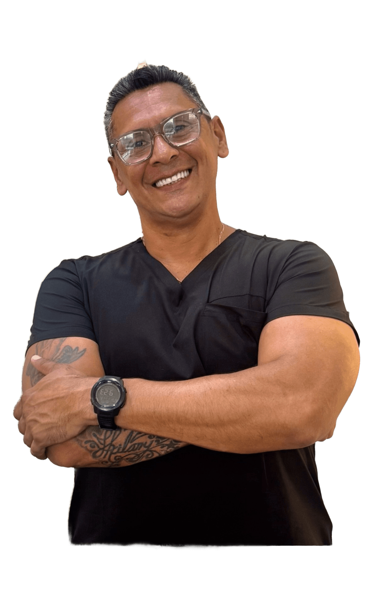 Jose Velandia — chiropractor and founder of Ouchless, arms crossed in black scrubs