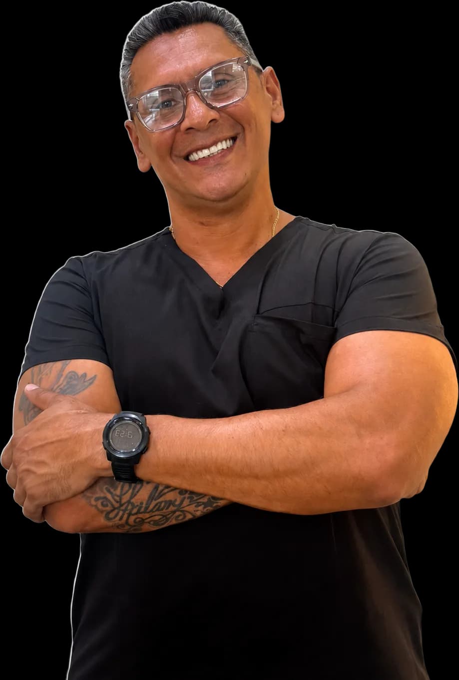 Jose Velandia — chiropractor and founder of Ouchless, arms crossed in black scrubs